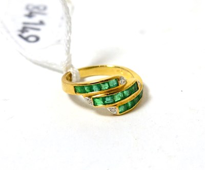 Lot 483 - An emerald and diamond ring, three bands of step cut emeralds in yellow channel settings, each band