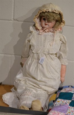 Lot 1023 - Large bisque shoulder head doll, on kid leather body, with blond wig, sleeping blue eyes, open...