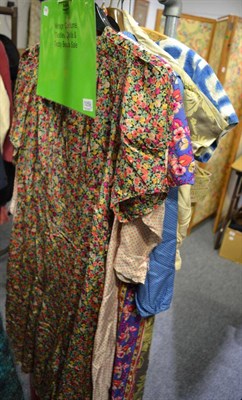 Lot 1059 - Assorted circa 1950's and later dresses, including a floral day dress, brocaded evening wear...