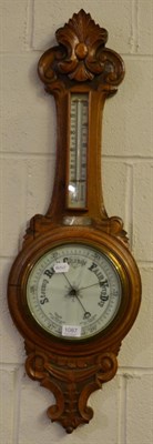 Lot 1087 - Two carved oak aneroid barometers