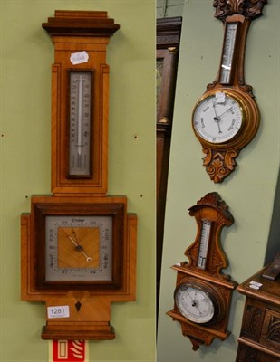 Lot 1281 - Two carved oak aneroid barometers and another Art Deco aneroid barometer (3)