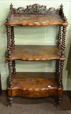 Lot 1284 - A Victorian bur walnut three tier whatnot fitted with a base drawer