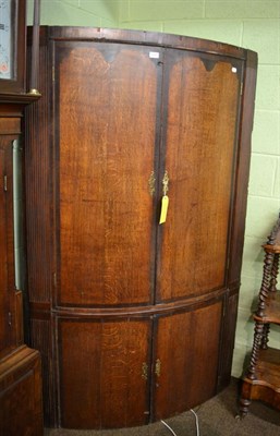 Lot 1285 - A large mahogany and oak bow-fronted corner cupboard