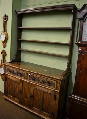 Lot 1287 - A carved oak dresser and rack