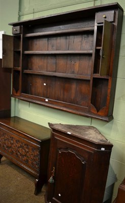 Lot 1289 - A George III oak hanging corner cupboard, late 18th century, with a bold cornice above a...