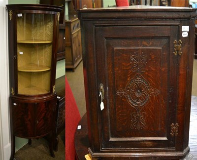 Lot 1291 - A glazed mahogany silk lined standing corner pitrine, together with a George III carved oak hanging