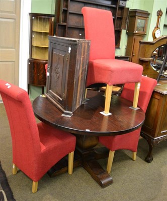 Lot 1292 - A modern oak circular pedestal dining table together with four modern red upholstered chairs