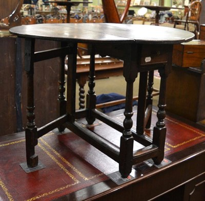 Lot 1303 - A late 17th century oak drop leaf occasional table, with single frieze drawer, raised on...