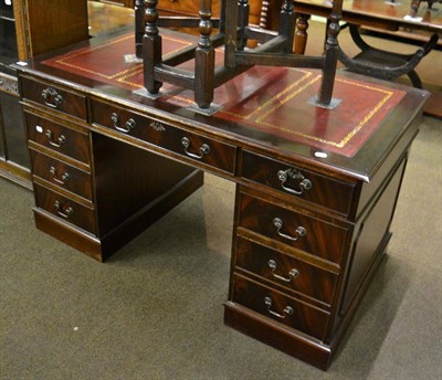 Lot 1304 - A leather inset mahogany twin pedestal knee hole desk