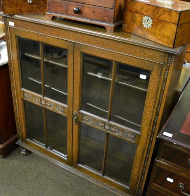 Lot 1306 - A glazed oak bookcase