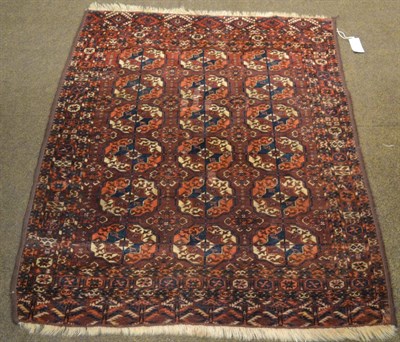 Lot 1325 - A 19th century Tekke rug, Emirate of Bukhara, the deep madder field with 3 columns of quartered...