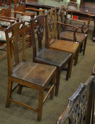 Lot 1333 - Five various George III oak chairs comprising three plank seated examples, each with yoke crest...