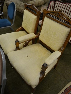 Lot 1343 - An early 20th century pair of oak chairs, lady's and gent's, spindle backs, upholstered overstuffed