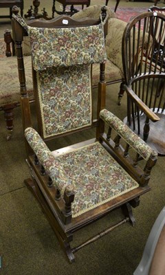 Lot 1345 - A upholstered American style rocking chair