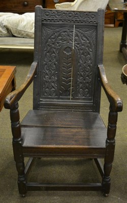 Lot 1351 - An 18th century carved oak open arm chair