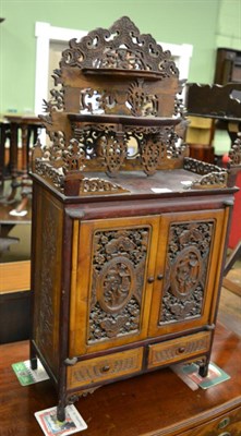 Lot 1363 - A Chinese carved wooden table top cabinet, with ornately pierced super structure above carved...