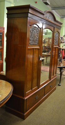 Lot 1373 - An early 20th century mahogany mirror fronted wardrobe with Art Nouveau carved panels, with ivorine