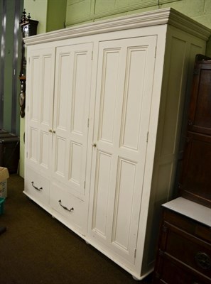 Lot 1391 - A white painted pine triple wardrobe