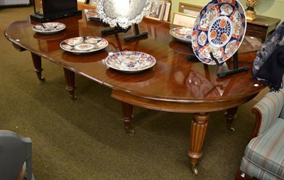 Lot 1398 - A Victorian mahogany rounded rectangular extending dining table, with two spare leaves, on tapering