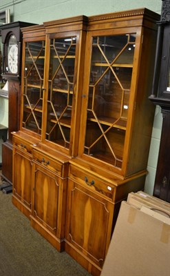 Lot 1404 - A yew wood reproduction astragal glazed break front bookcase&nbsp