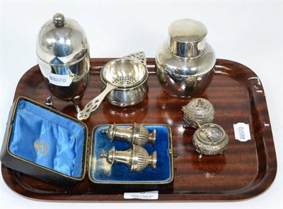Lot 6 - A group of silver comprising pair of cased peppers, tea strainer and stand, caddy, Indian...