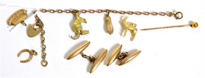 Lot 47 - A charm bracelet, three loose charms, a stick pin and a pair of cufflinks