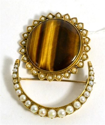 Lot 71 - A tiger's eye and seed pearl brooch and a mabe pearl set crescent brooch (2)