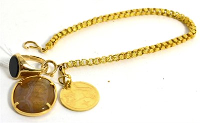 Lot 77 - A 9ct gold signet ring, a 9ct gold zodiac medallion, a carved hardstone fob and a part chain