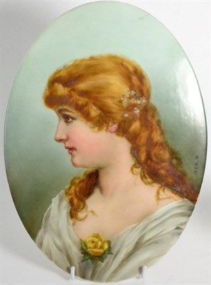 Lot 104 - An oval porcelain plaque painted with a young woman, signed and dated ";A E M 88"