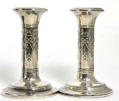 Lot 108 - A pair of Edwardian silver candlesticks