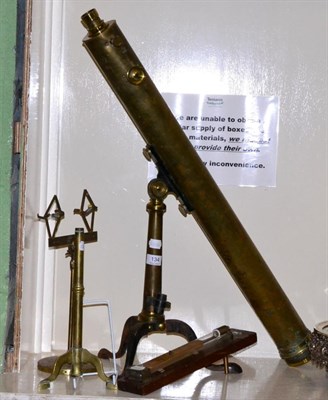 Lot 134 - A brass telescope on stand, two other brass stands and a double table scale T.B Winter & Son...