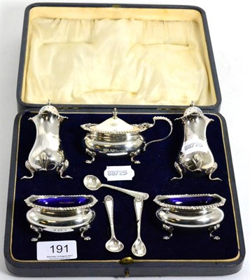 Lot 191 - A cased set of silver salts with blue glass liners, peppers and three spoons