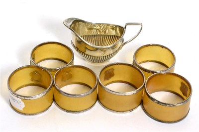 Lot 206 - Silver cream jug and a set of six silver mounted horn serviette rings