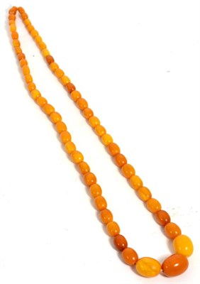 Lot 217 - An amber bead necklace, a continuous strand of graduated oval amber beads, the largest beads...