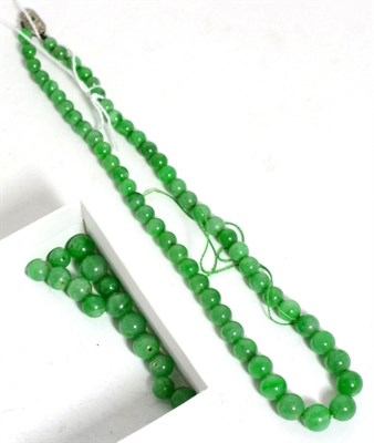 Lot 224 - A jade bead necklace, formed of graduated jade beads knotted to an emerald and diamond set...