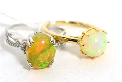 Lot 246 - A 14ct white gold opal and diamond ring and a 9ct gold opal ring, both finger size P1/2 (2)