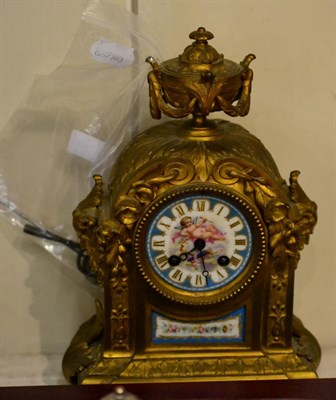 Lot 296 - A late 19th century French gilt metal and porcelain mantel clock, winder and pendulum