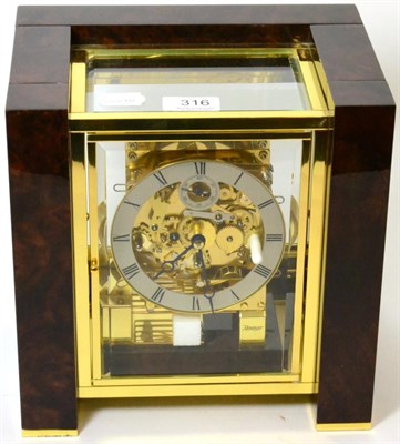 Lot 316 - A faux burr walnut modern chiming table clock, signed Kieninger