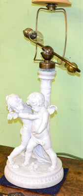 Lot 349 - A Parian figural table lamp decorated with putti