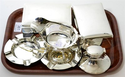 Lot 361 - A group of silver comprising two cigarette boxes, a pair of ashtrays a sauce boat, a Capstan...