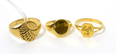 Lot 433 - A 9ct gold signet ring, an Isle of Man signet ring, stamped '9CT' and another signet ring (3)