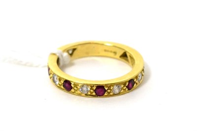 Lot 438 - An 18ct gold ruby and diamond eternity ring