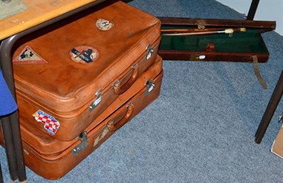 Lot 1046 - Two leather suitcases, gun case, two riding crops, Ghana tribal artifacts etc