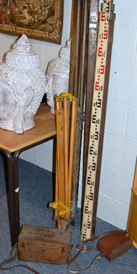 Lot 1051 - A group of surveyors equipment inlcuding rules, tripods etc