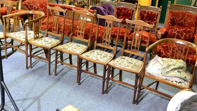 Lot 1059 - A set of six chairs including four dining chairs with yoke crest rails and a pair of barrel...