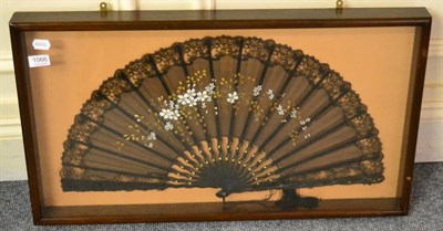 Lot 1066 - A framed and glazed silk fan with carved wooden sticks