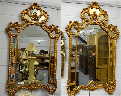 Lot 1067 - A pair of reproduction gilt framed mirrors in the rococo taste