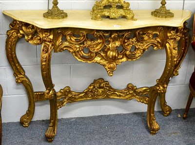 Lot 1072 - A reproduction gilt composition console table