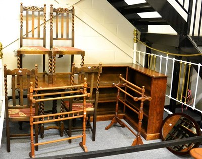 Lot 1076 - A 1920's oak dining suite comprising a table and four chairs, together with a corner bookcase...