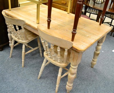 Lot 1094 - A pine breakfast table and two chairs